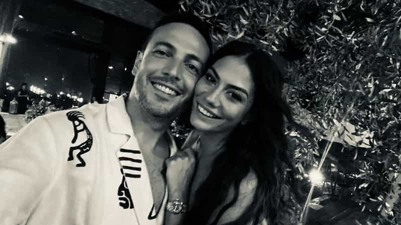 black and white photo of demet özdemir smiling, cheek to cheek with future husband oğuzhan koç, who wears a white t-shirt smiling wedding divorce