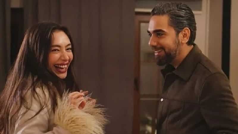 gecenin ucunda end dizi series Neslihan Atagül wearing a pink fluffy jacket smiling, with  Kadir Doğulu wearing a brown jacket smiling and looking at his wife 