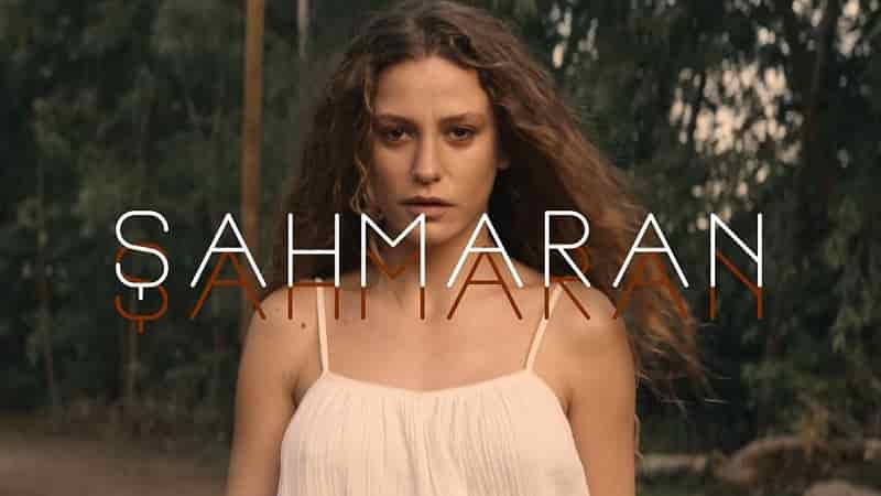 Serenay Sarıkaya with blond long curly hair and white dress in forest, caption reads Şahmaran, Burak Deniz Turkish mitologhy