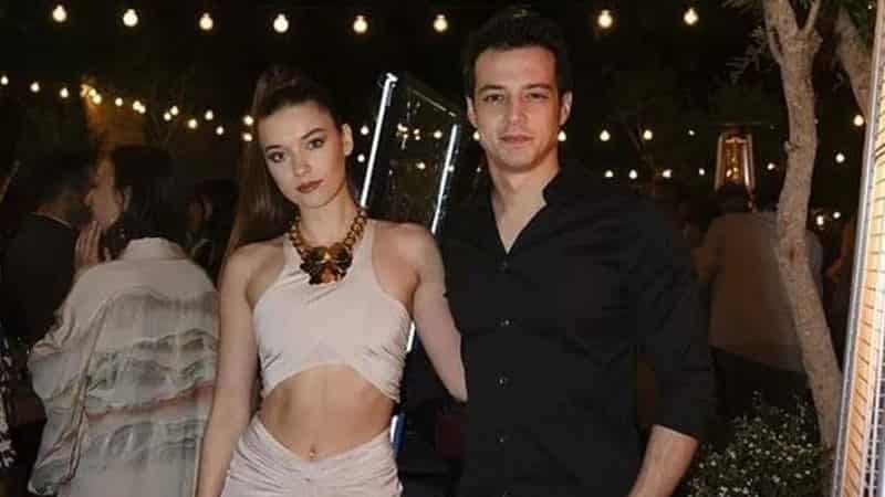 Afra Saraçoğlu wearing a pink dress with belly out at the arm of her ex-boyfriend Mert Yazıcıoğlu wearing a black t-shirt yali capkini dizi series