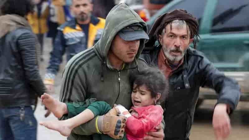 Devastating 7.8 Magnitude Earthquake Strikes Turkey and Syria , a man holding a young girl in his arms, with an older man helping him
