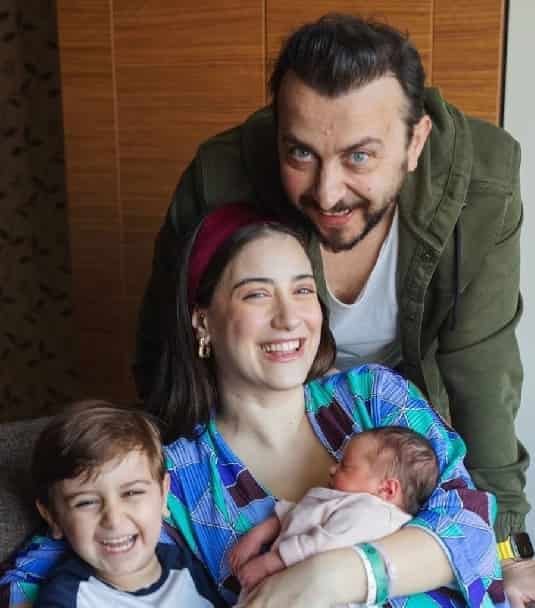 turkish actors Ali Atay and Hazal Kaya holding her baby girl leyla and boy