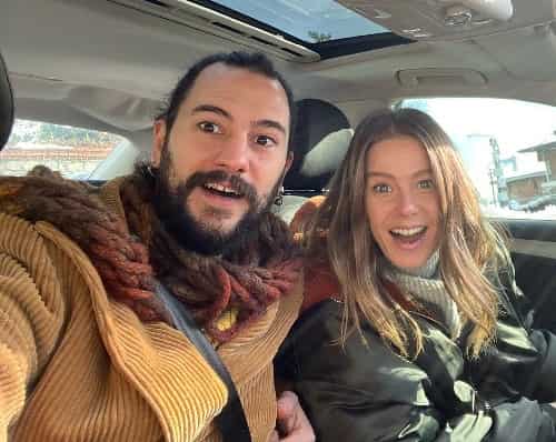 Is Burcu Biricik Pregnant, next to her husband making a couple selfie in the car, laughing while in france