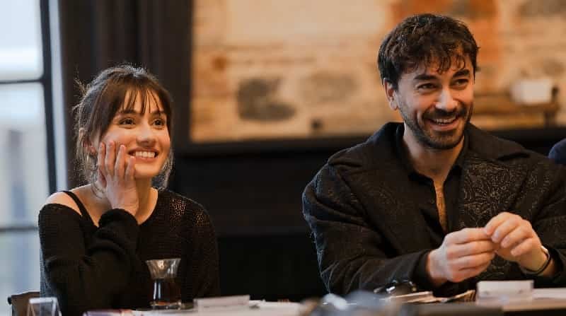new turkish trt dizi series Kül Masalı featuring Gökhan Alkan and Sevda Erginci sitting at the table, smiling an reading the script