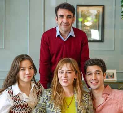 Demet Evgar and Mehmet Yılmaz Ak and theri two children sitting on couch